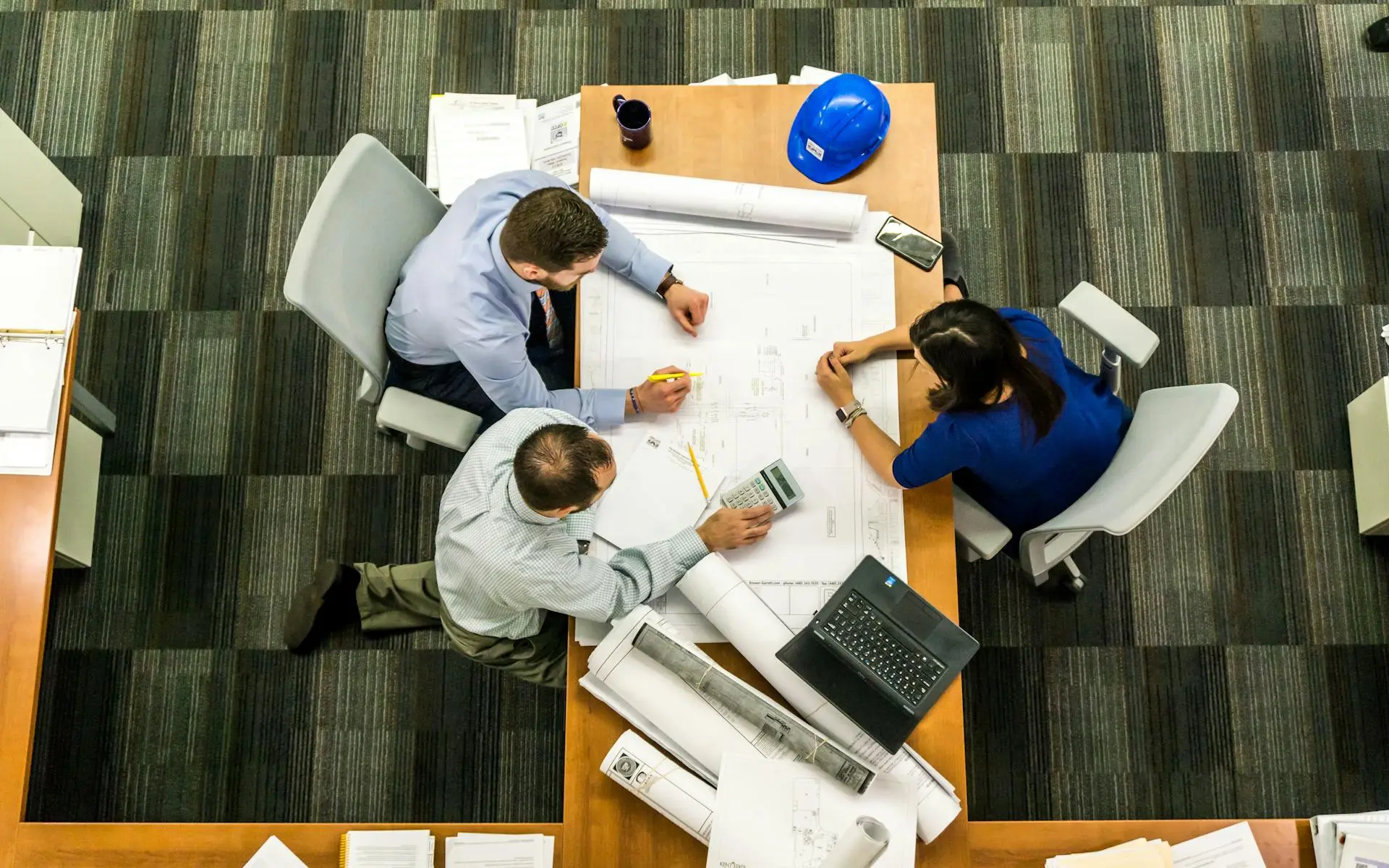 Engineers discussing building plans