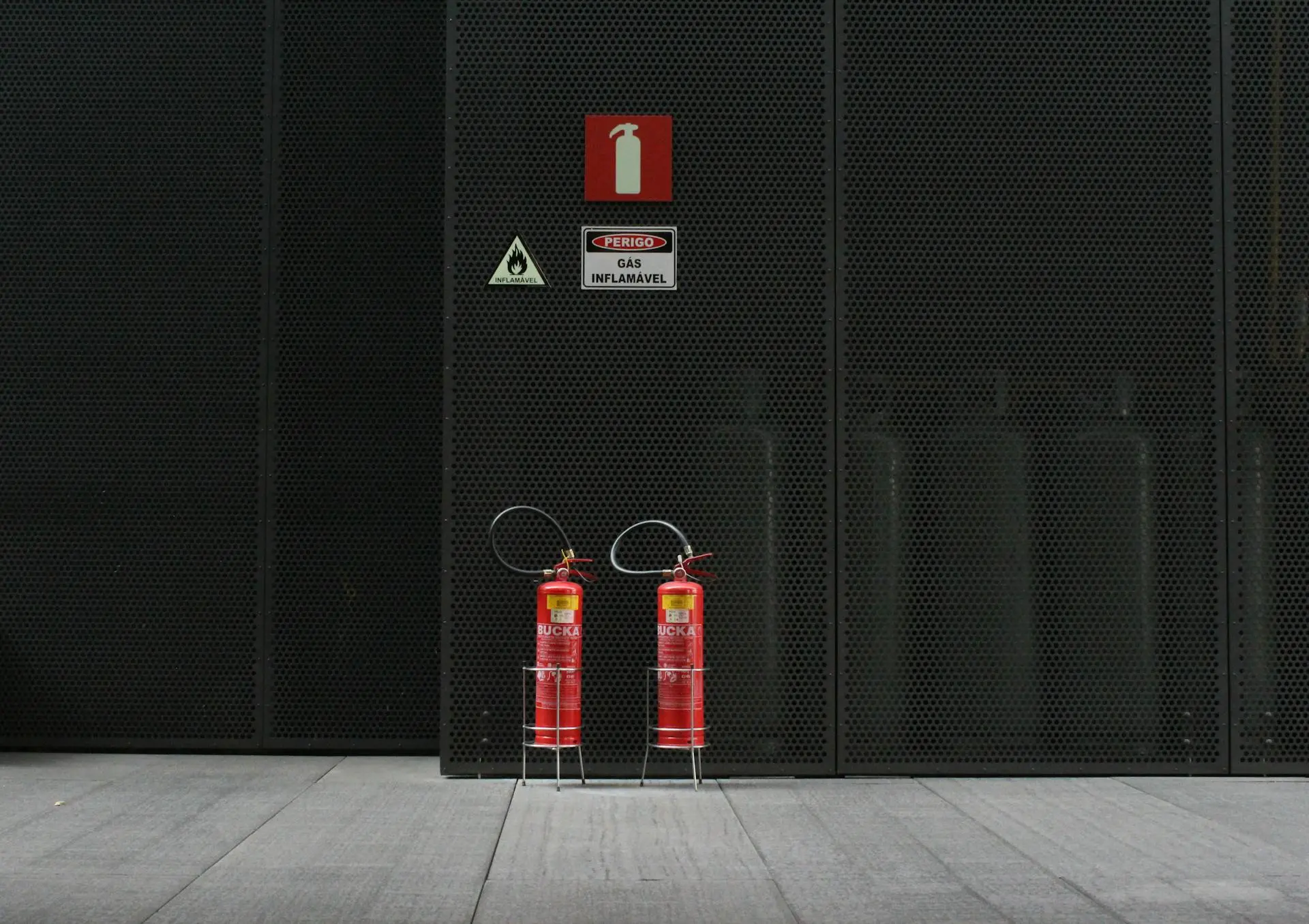 Fire extinguishers on black mesh background